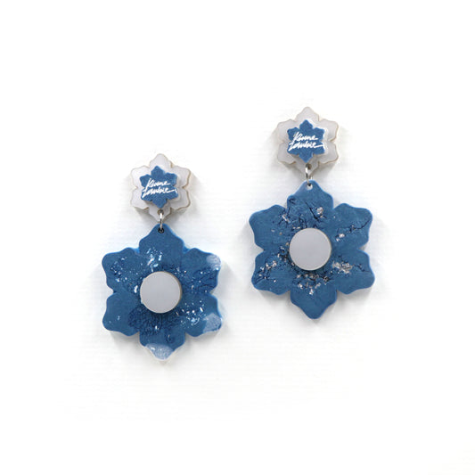 blue and white marbled resin flower statement clip on earrings on a white background