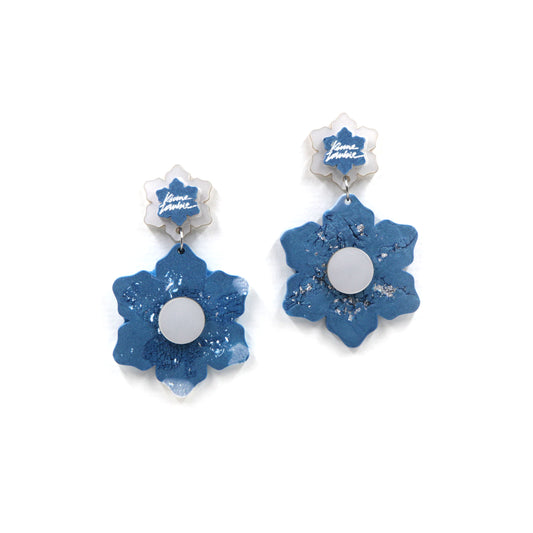blue and white marbled resin flower statement clip on earrings on a white background