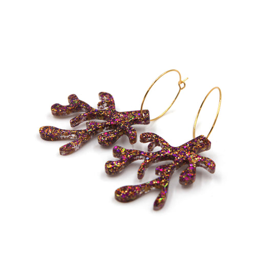 side view of purple glitter resin coral gold plated hoop earrings on a white background