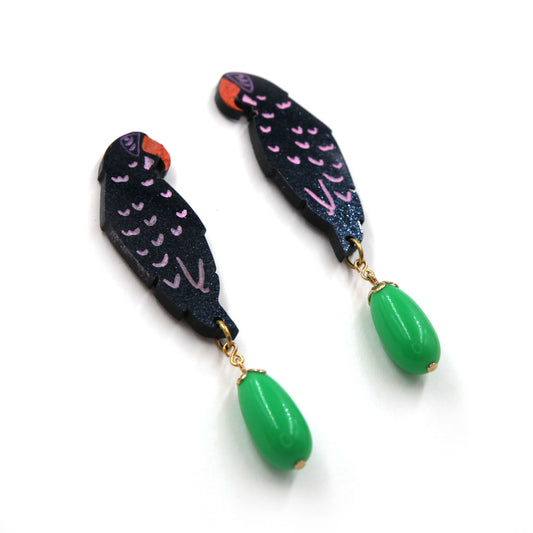 side view of laser cut parrot statement earrings, hand painted with  green vintage beads on a white background