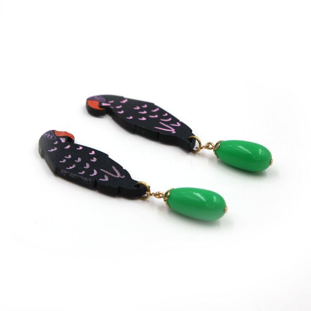 other side view of laser cut parrot statement earrings, hand painted with green vintage beads on a white background