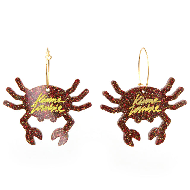 Orange glitter resin crab gold plated hoop earrings on a white background