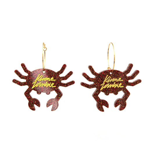 other view of Orange glitter resin crab gold plated hoop earrings on a white background