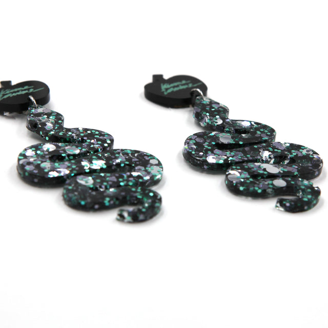 side view of glitter resin snake statement apple clip-on earrings on a white background