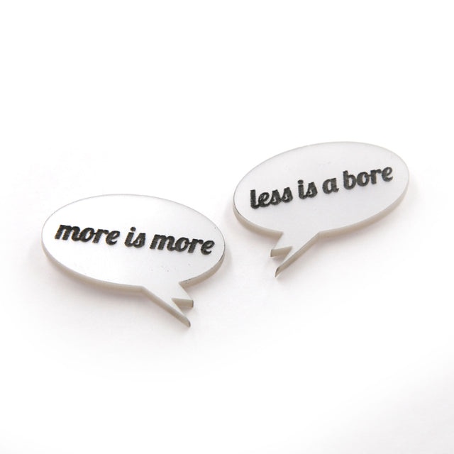 other side view of More is more & less is a bore - Laser cut acrylic speech bubble pin brooches on a white background