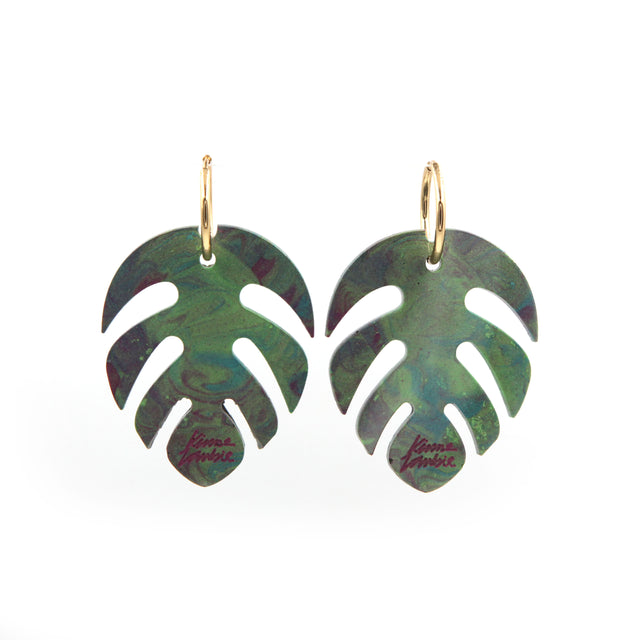 other view of green and pink marbled resin monstera leaves statement gold plated hoop earrings on a white background