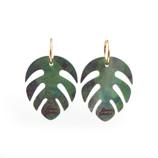 other view of green and pink marbled resin monstera leaves statement gold plated hoop earrings on a white background