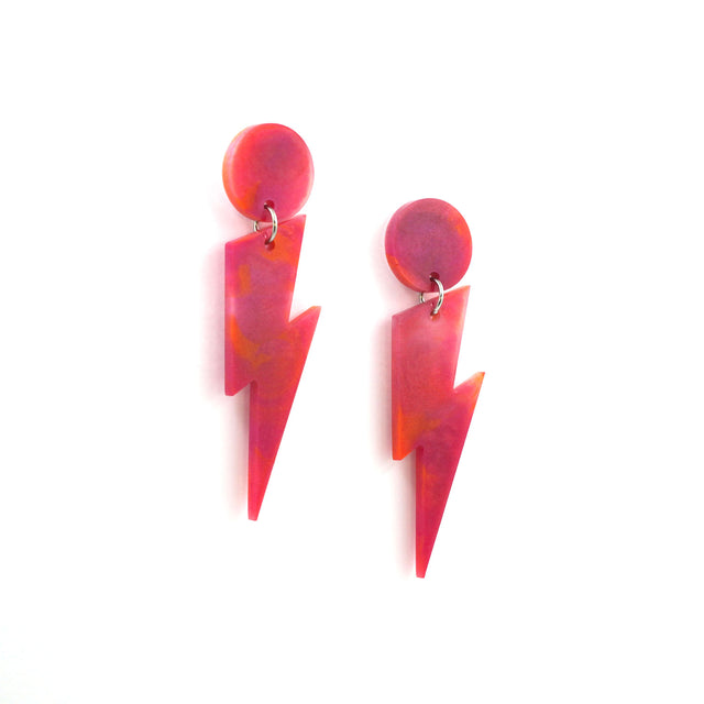 this is a picture of pink and orange marbled bolt and dot dangle earrings on a white background.