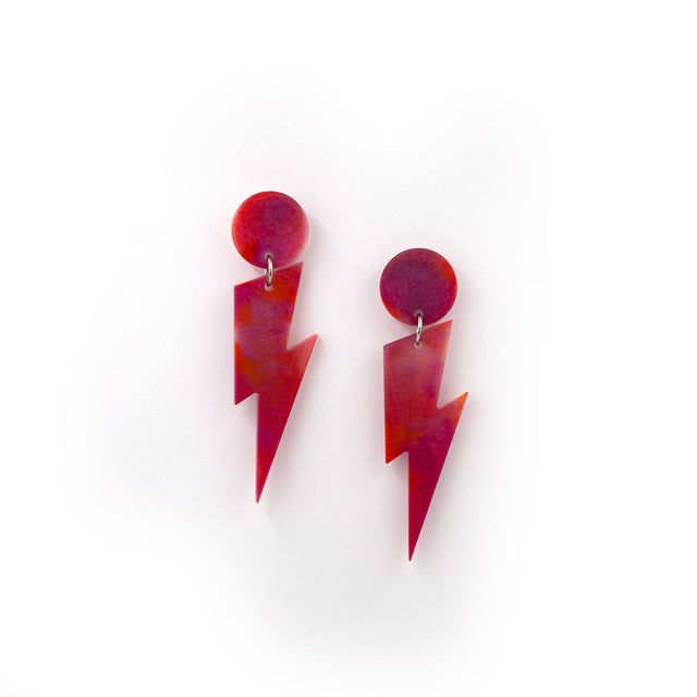 this is a picture of pink and orange marbled bolt and dot dangle earrings on a white background.