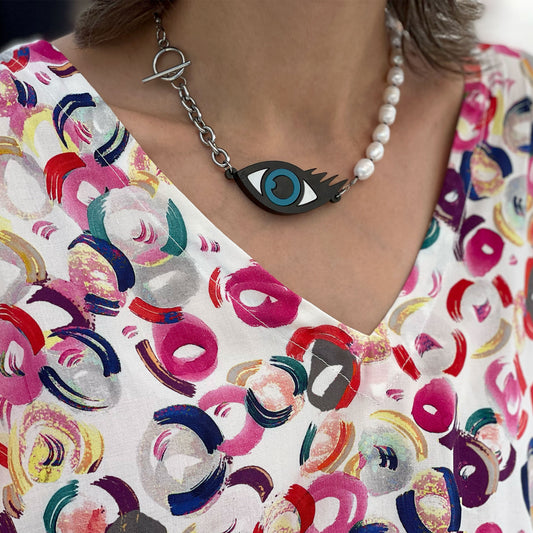 Woman wearing an evil eye necklace with pearls