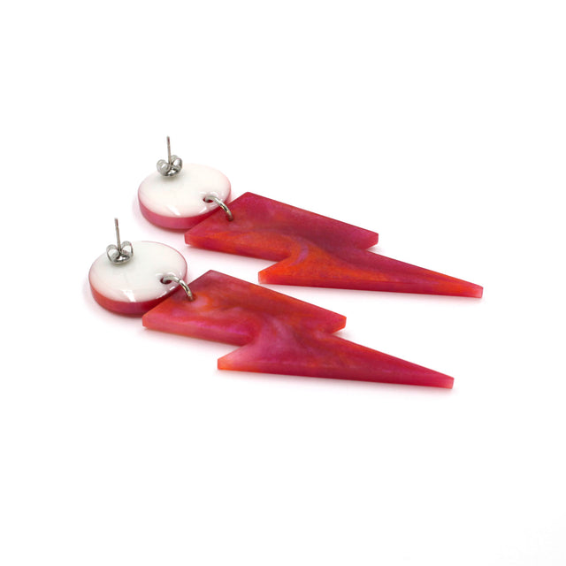 this is a picture of pink and orange marbled bolt and dot dangle earrings on a white background. one is on the back, the stud are silver on a white dot.