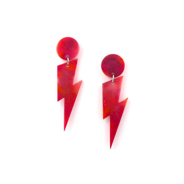 this is a picture of pink and orange marbled bolt and dot dangle earrings on a white background.