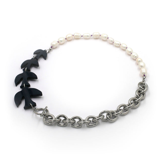 this is a necklace with a chunky chain then pearls then birds on a white background.