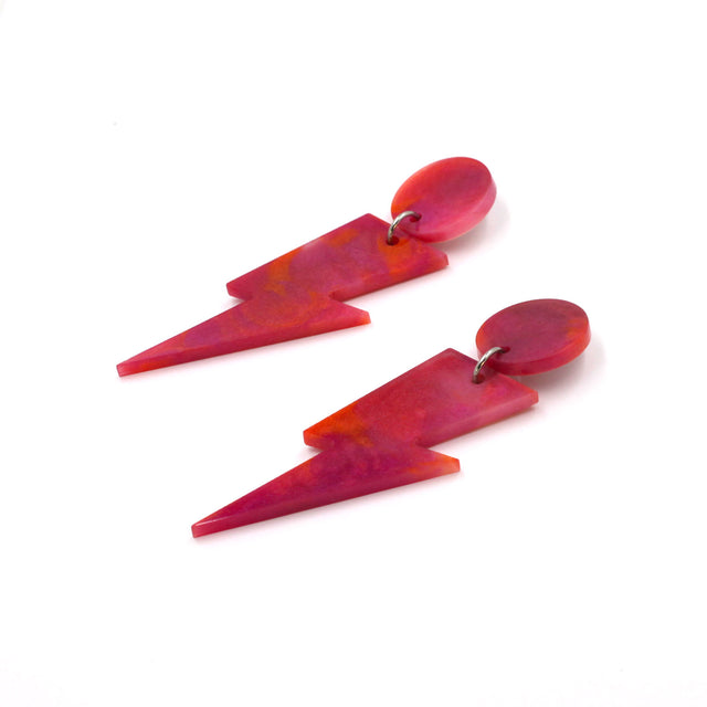 this is a picture of pink and orange marbled bolt and dot dangle earrings on a white background.