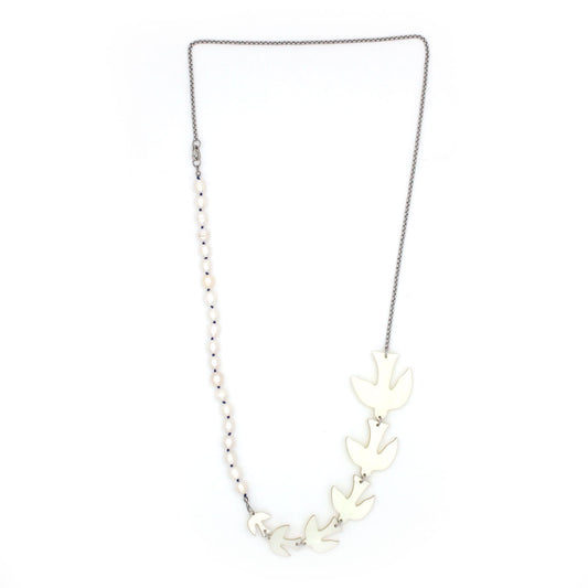 A long necklace is hanging from a white background, composed of pearls hand knotted silk thread, 6 birds large to small size and a thin silver tone chain. 