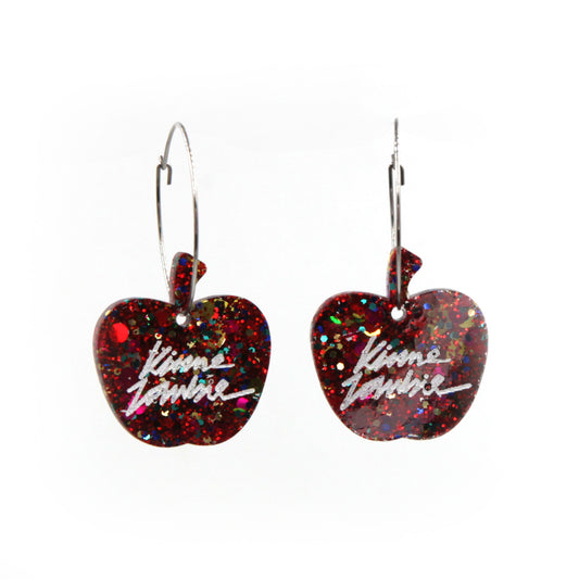 close up of red glitter resin apple stainless steel hoops earrings on a white background