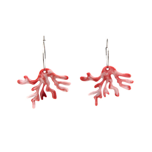 close up of white and light red resin coral hoops earrings on a white background