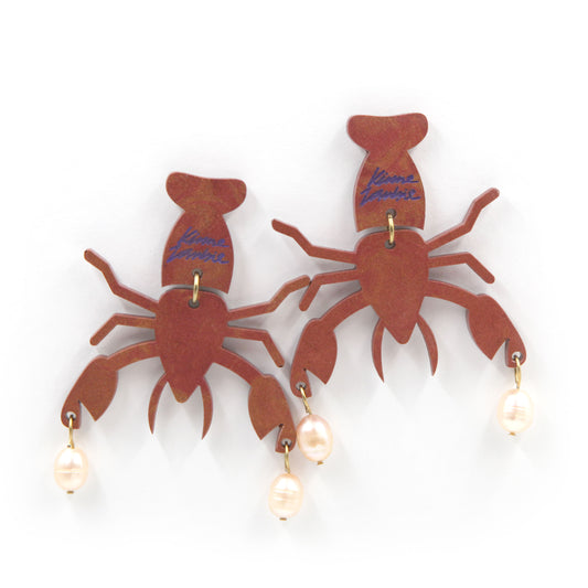 resin lobster with peach freshwater pearls gold plated earrings on a white background