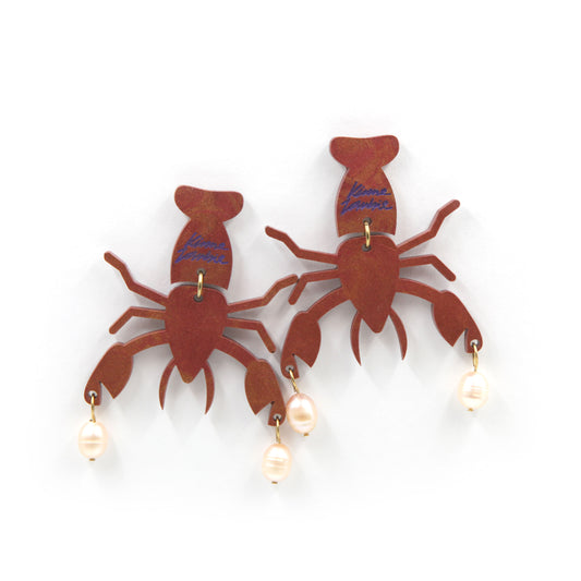 other view of resin lobster with peach freshwater pearls gold plated earrings on a white background