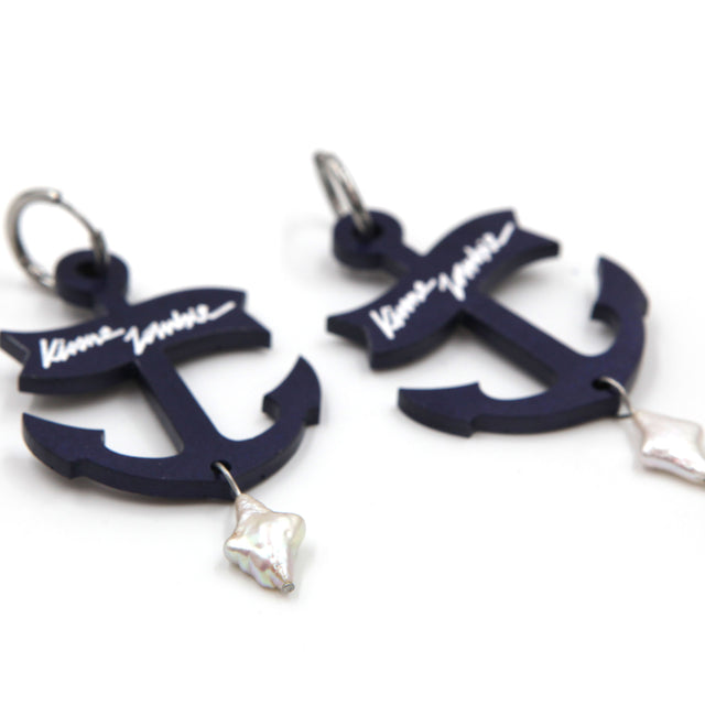 other side view of statement navy blue resin anchor with freshwater pearls hoop earrings on a white background