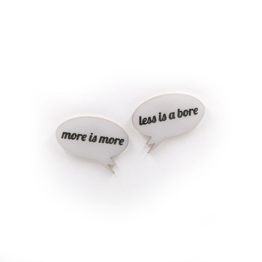 More is more & less is a bore - Laser cut acrylic speech bubble pin brooches on a white background