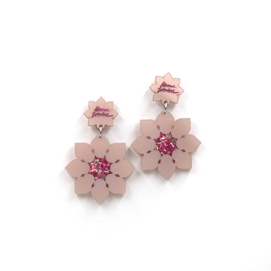 Pink pearly laser-cut acrylic lotus flowers earrings on a white background
