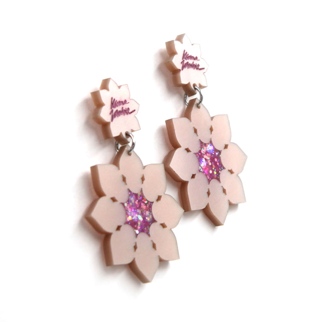 side view of Pink pearly laser-cut acrylic lotus flowers earrings on a white background