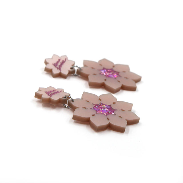 other side view of Pink pearly laser-cut acrylic lotus flowers earrings on a white background