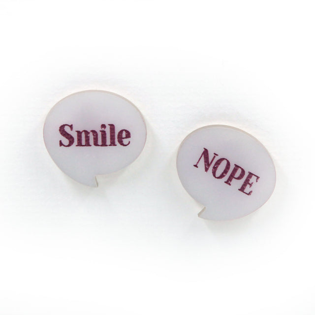 smile & nope laser cut pearly white acrylic pin brooches. one say smile, the other one nope. on a white background.