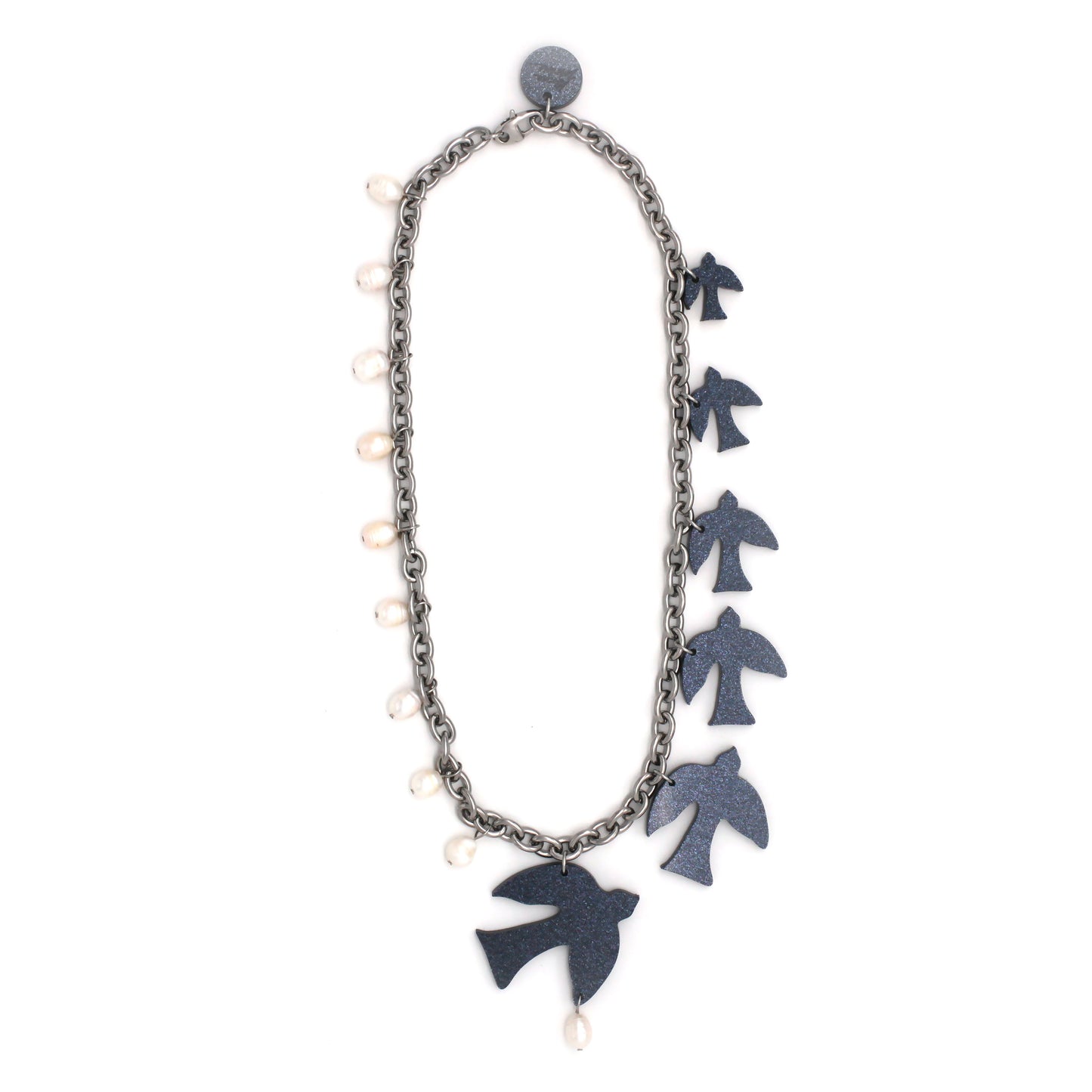 Dark blue glittery acrylic, laser-cut birds, and white freshwater pearls hanging on a thick steel chain on a white background.