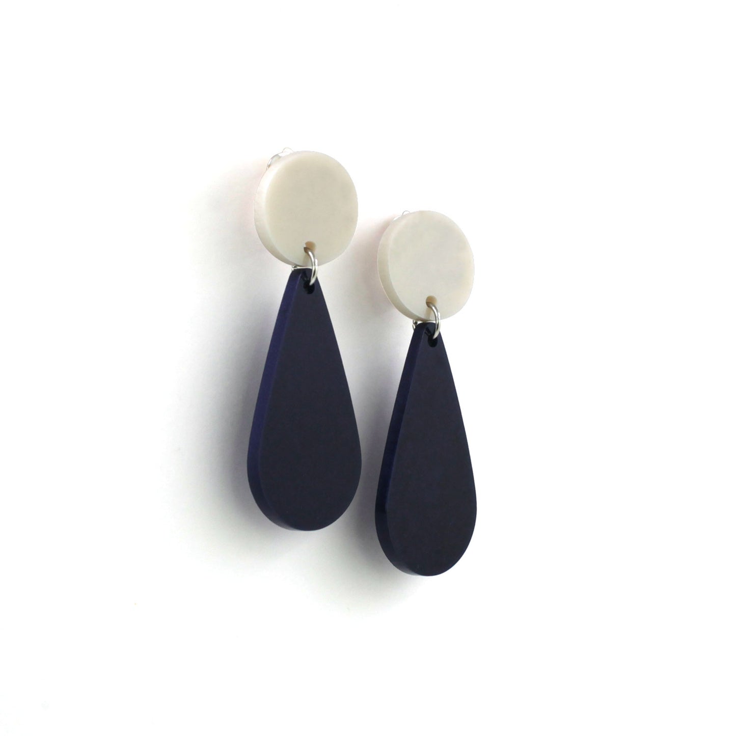 This is a picture of a teardrop dangle earrings on a white background. the top of the earrings is a white dot and the teardrops are navy blue