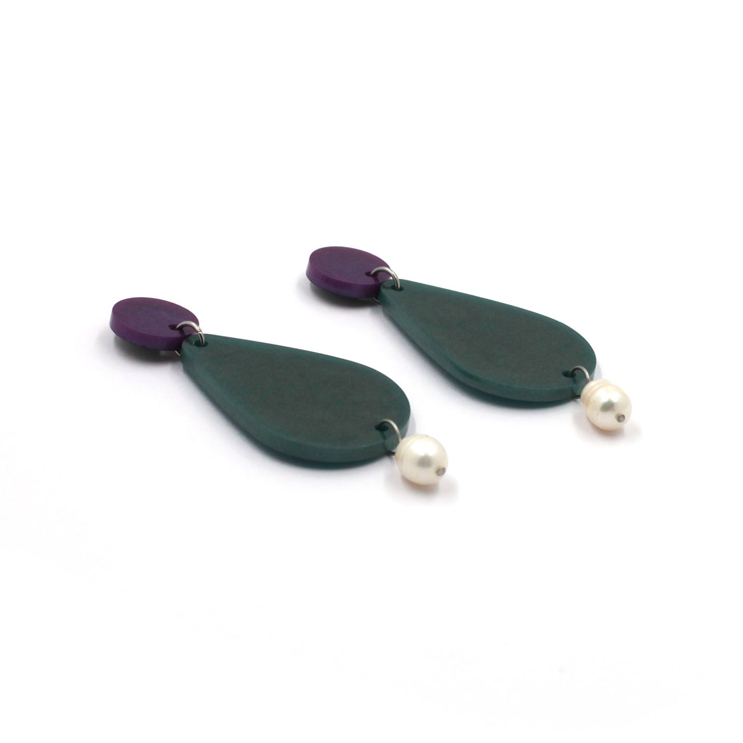 picture of earrings on a white background. the earrings are composed by a purple dot at the top, then a bigger green pear shape and a freshwater pearls at the bottom hanging.