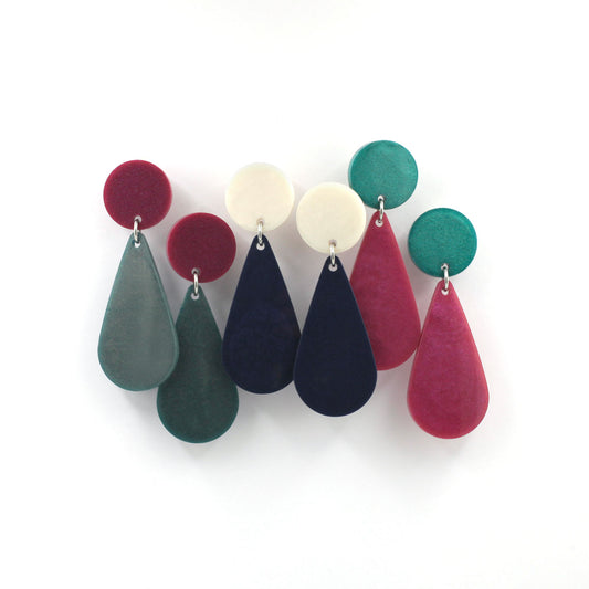 this is a picture of three pairs of earrings from the same style but different color. The top of the earrings is a dot and the pendant is a teardrop. one is green and pink, one is blue and white, one is pink and green.