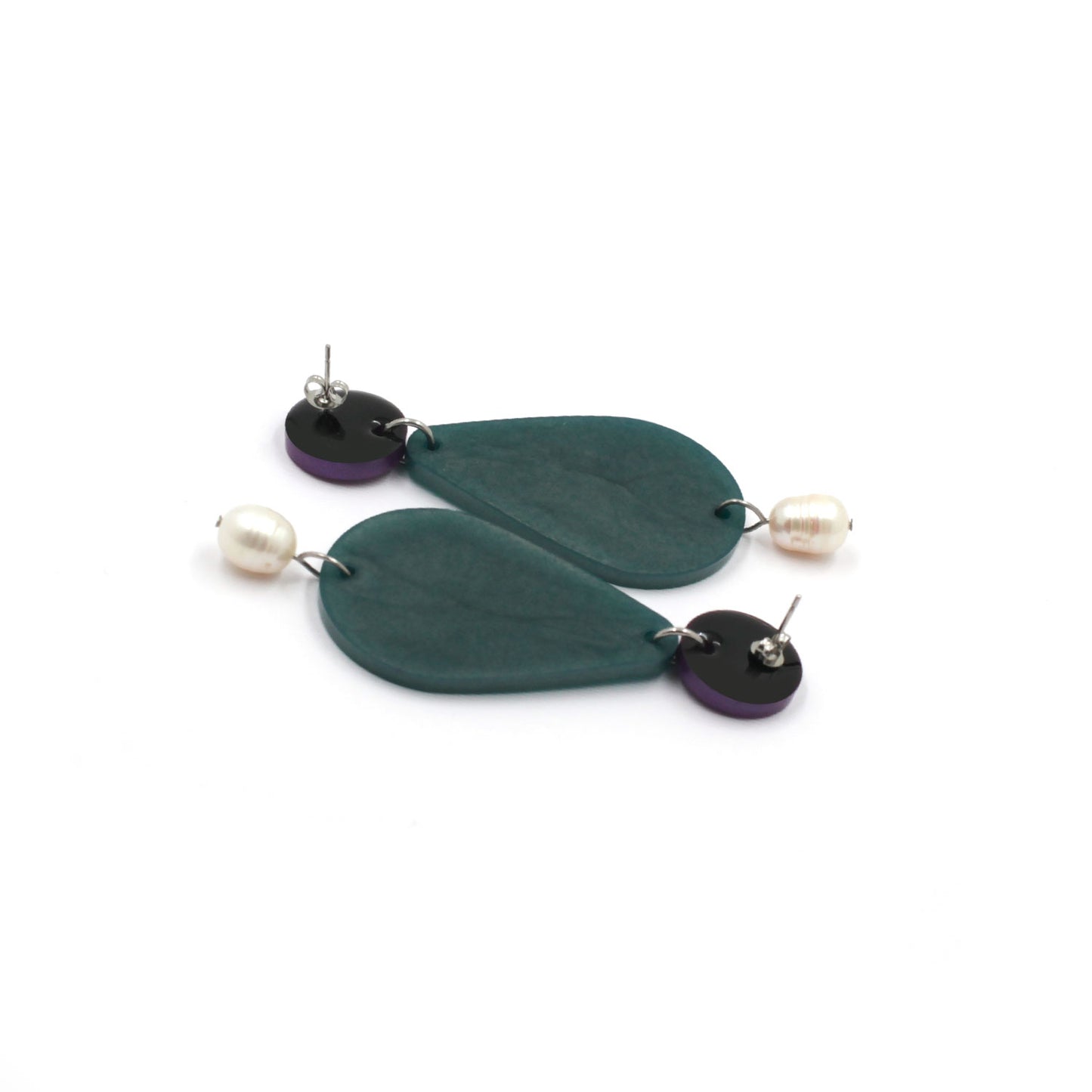back of stud earrings composed by freshwater pearls, green pear and a dot on a white background