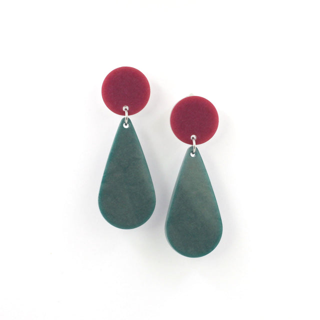 This is a picture of a teardrop dangle earrings on a white background. the top of the earrings is a dark pink dot and the teardrops are forest green