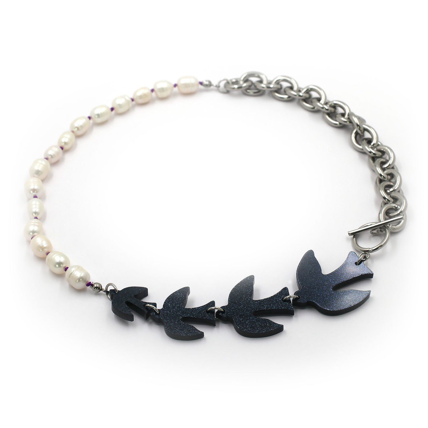 this is a collar necklace composed by four black glitters birds than pearls with a purple thread and a big chunky chain. the clasp is a  t bar. the background is white.  