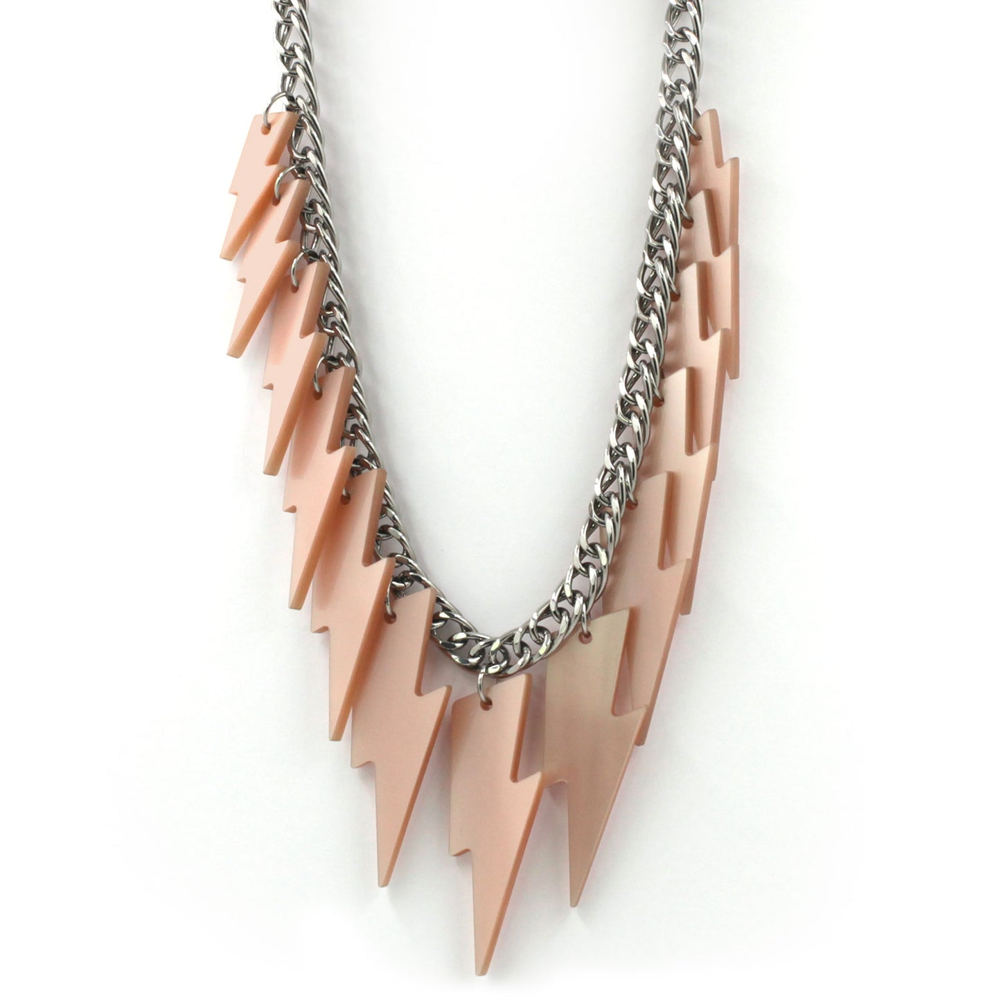close up of a necklace hanging on a white back ground, composed of a chunky silver tone curb chain with 13 pieces of pink pearly lightning bolts of graduant size.