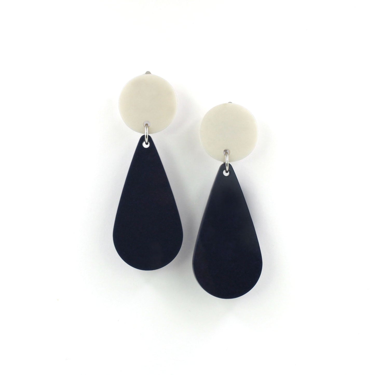 This is a picture of a teardrop dangle earrings on a white background. the top of the earrings is a white dot and the teardrops are navy blue