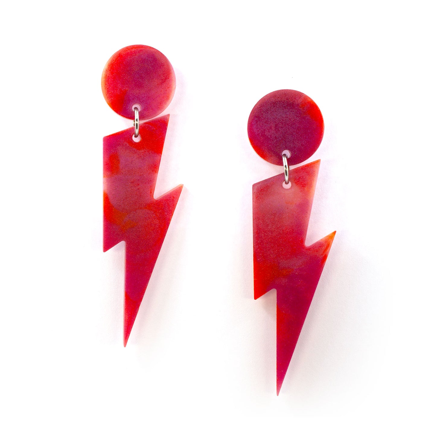 this is a picture of pink and orange marbled bolt and dot dangle earrings on a white background.
